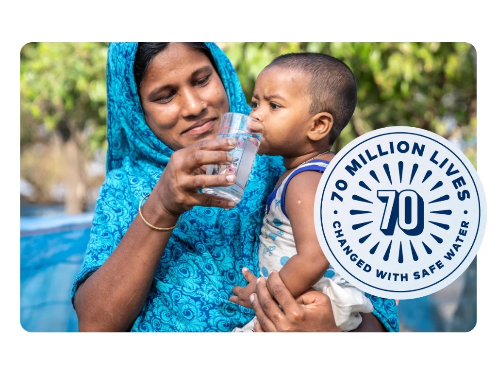 Mother and child with clean water - 70 Million lives changed