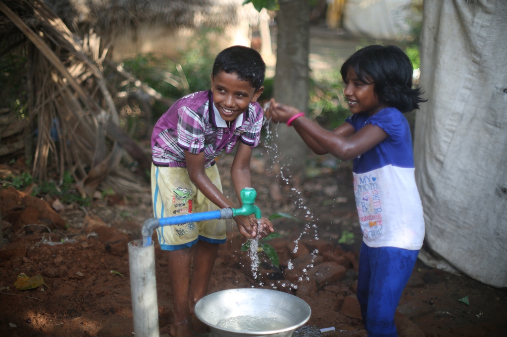 Happy children with household clean water tap